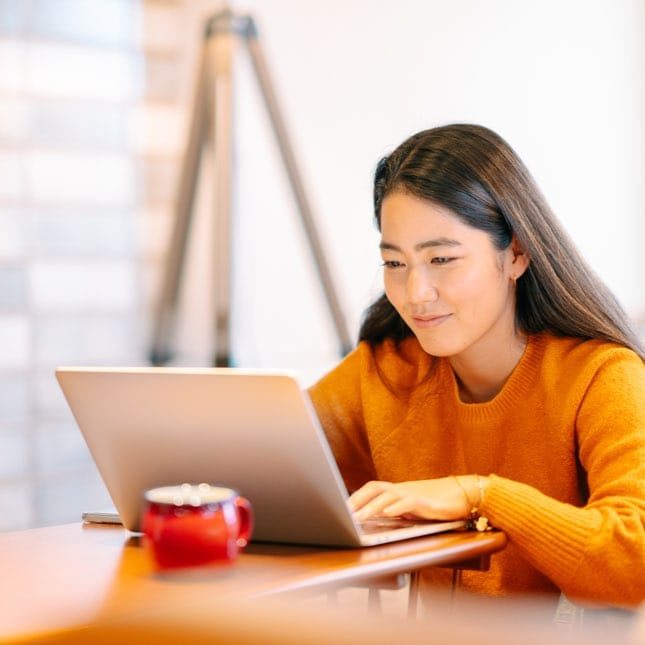 Young Woman Using Laptop to Find Opportunities